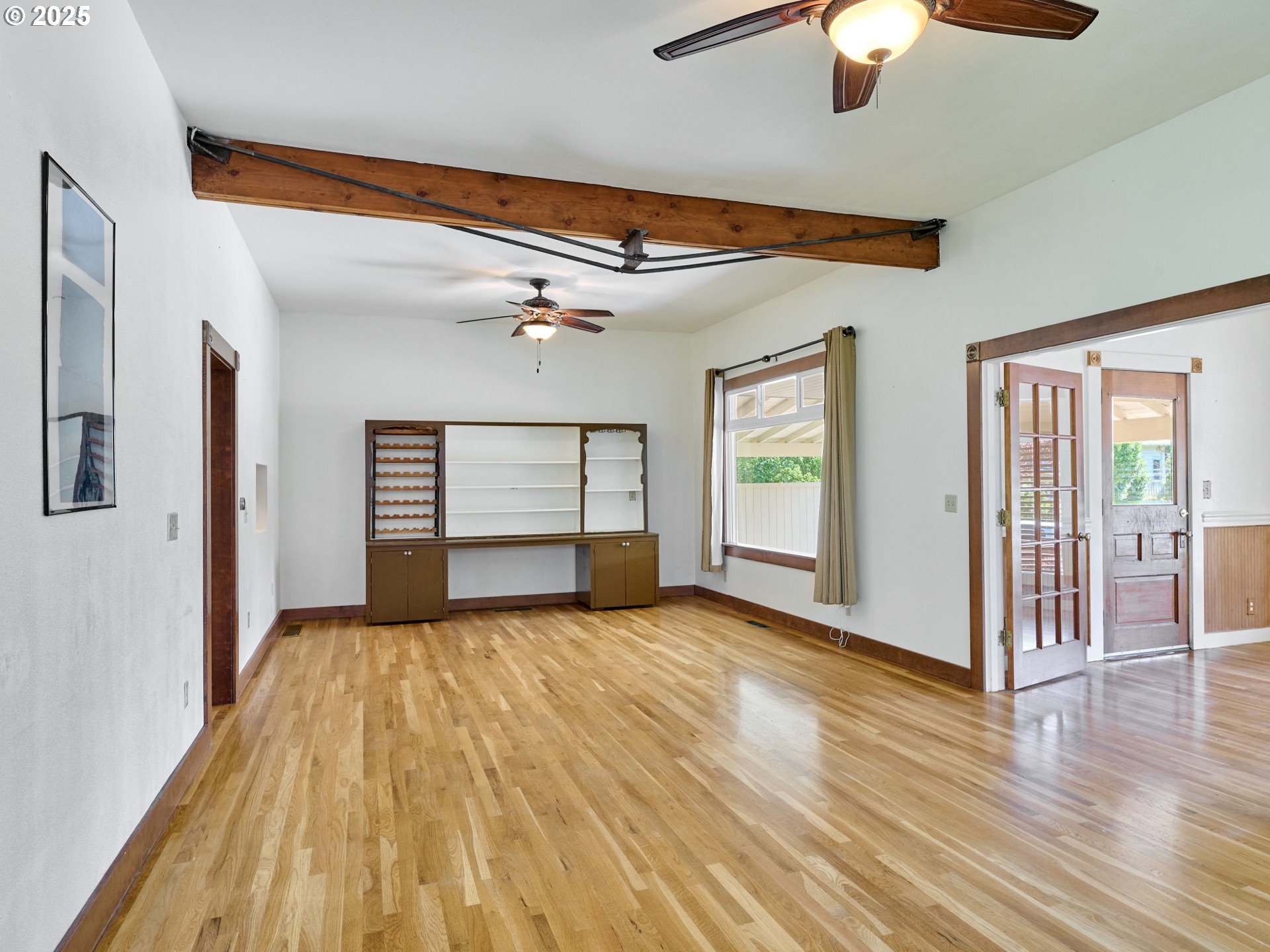 795 Corby Street Woodburn, OR 97071 - Photo 7 of 44 a view of an empty room with window and wooden floor