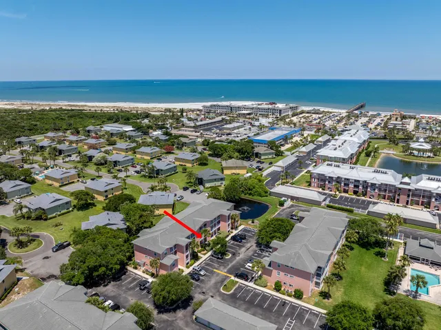 an aerial view of residential building and ocean
