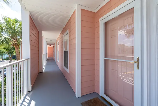 a view of a hallway with wooden floor and entryway
