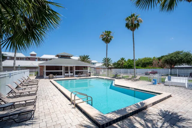 a view of a swimming pool with a table and chairs