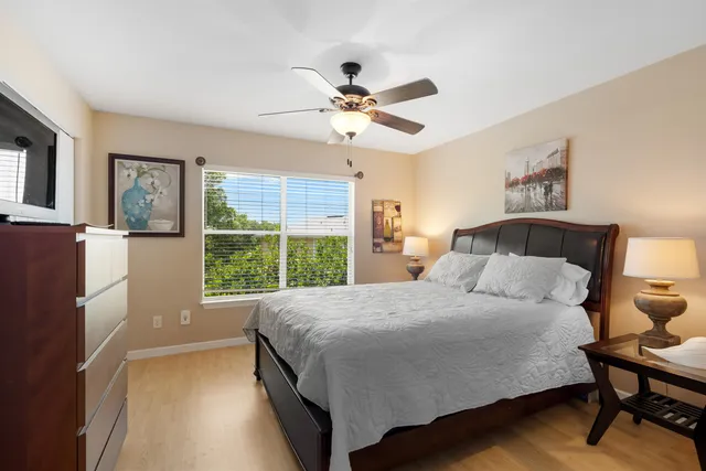a bedroom with bed and a chandelier