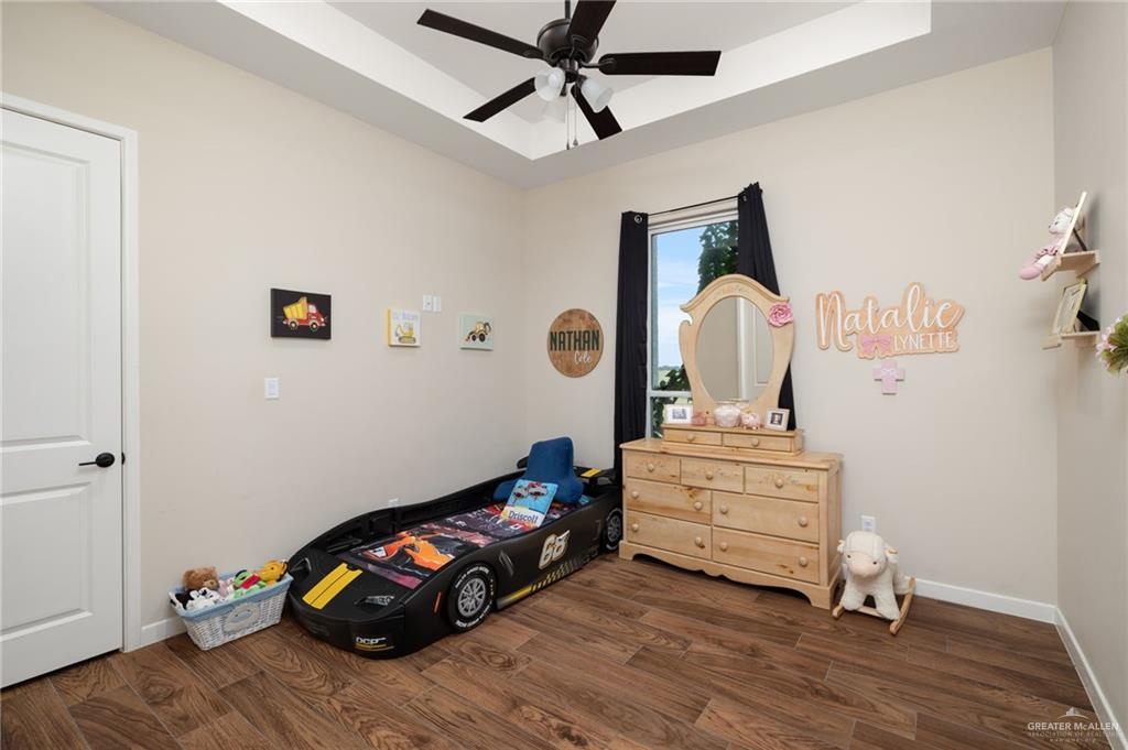 4650 North Big 5 Road Edinburg, TX 78541 - Photo 11 of 26 a bedroom with a bed and wooden floor