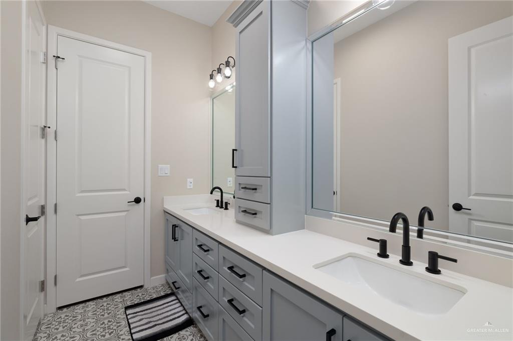 4650 North Big 5 Road Edinburg, TX 78541 - Photo 12 of 26 a bathroom with a double vanity sink a mirror and a shower