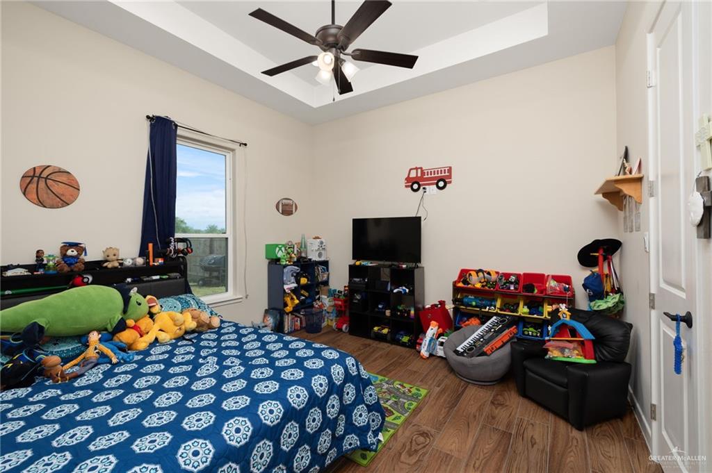 4650 North Big 5 Road Edinburg, TX 78541 - Photo 13 of 26 a bedroom with furniture and a flat screen tv