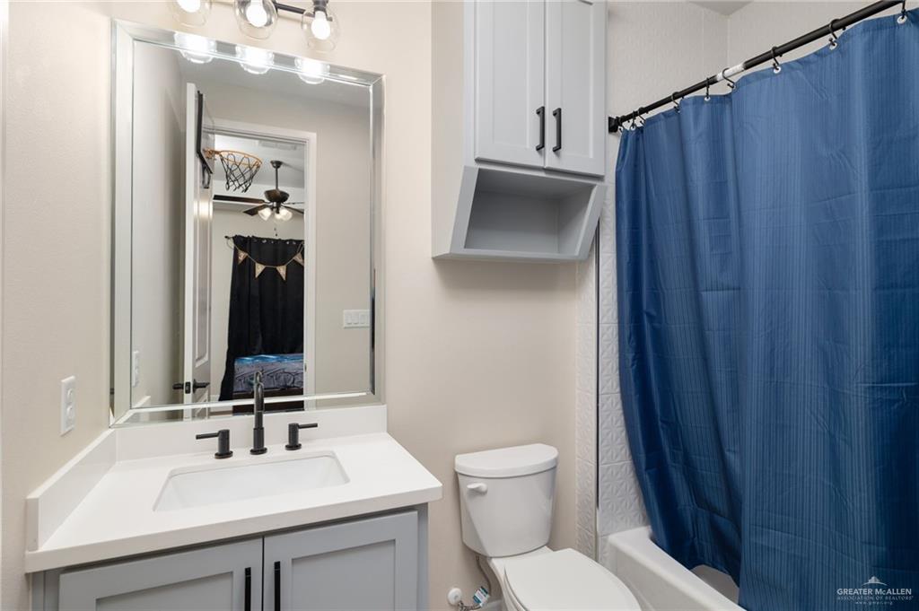 4650 North Big 5 Road Edinburg, TX 78541 - Photo 18 of 26 a bathroom with a sink vanity mirror and toilet
