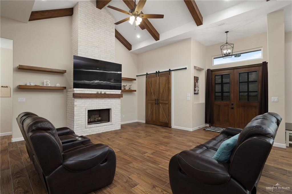 4650 North Big 5 Road Edinburg, TX 78541 - Photo 2 of 26 a living room with furniture a flat screen tv and a fireplace