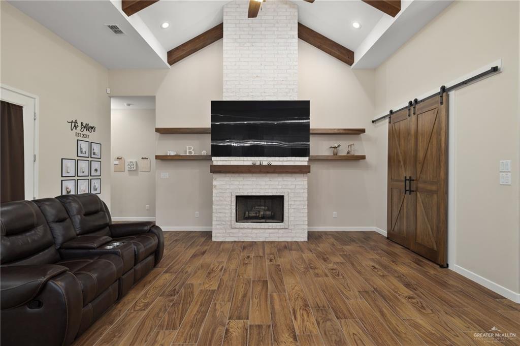 4650 North Big 5 Road Edinburg, TX 78541 - Photo 3 of 26 a living room with furniture a flat screen tv and a fireplace