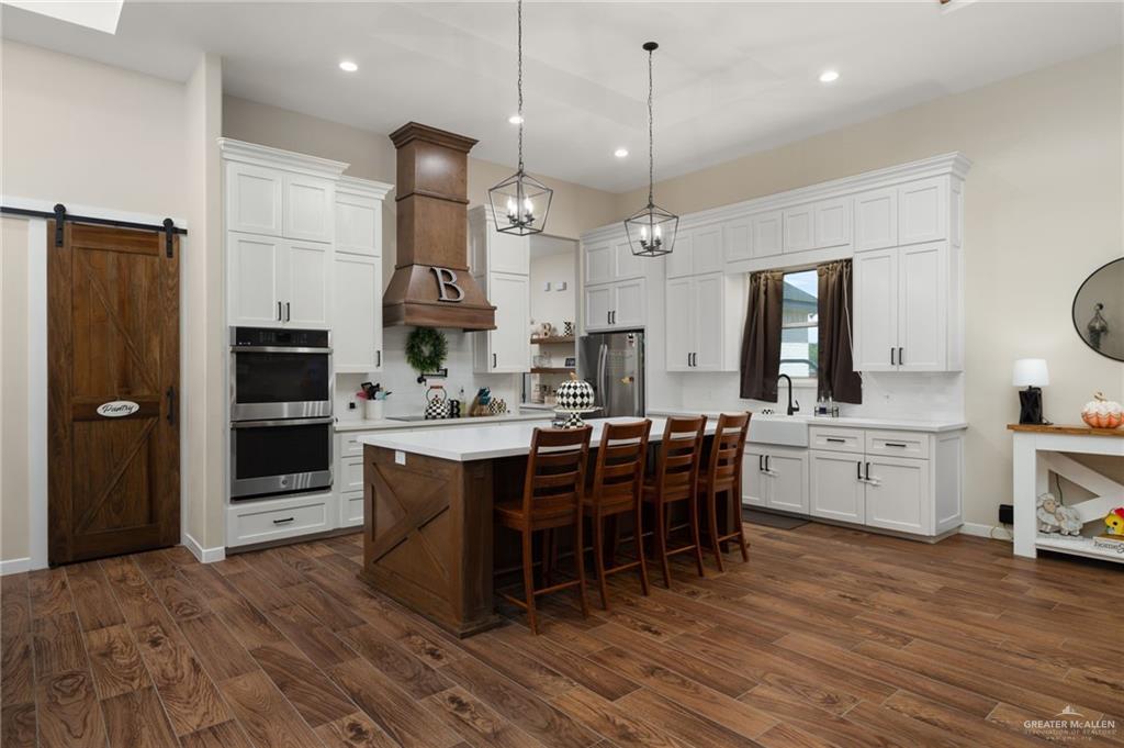 4650 North Big 5 Road Edinburg, TX 78541 - Photo 5 of 26 a large kitchen with a table and chairs in it