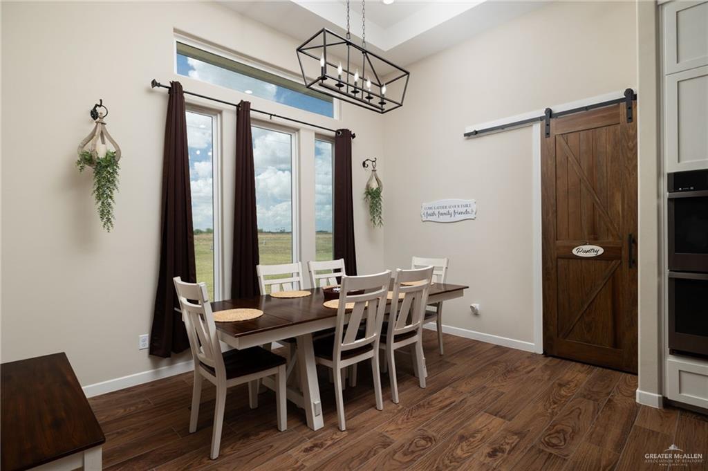 4650 North Big 5 Road Edinburg, TX 78541 - Photo 6 of 26 a view of a dining room with furniture window and wooden floor