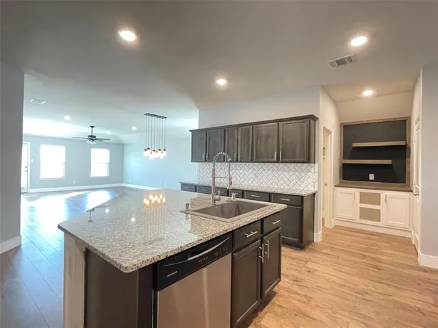 a kitchen with stainless steel appliances granite countertop a sink counter space and cabinets