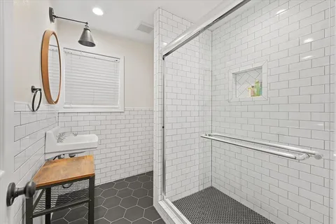 a bathroom with a sink a toilet and shower