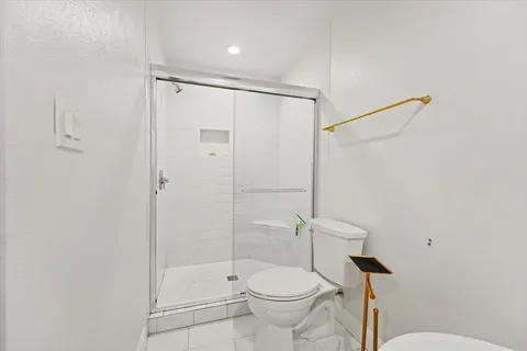 a bathroom with a toilet and shower
