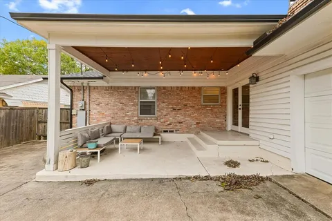 a view of a patio with table and chairs and wooden floor