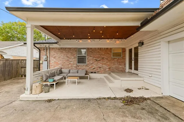 a view of a patio with table and chairs and wooden floor