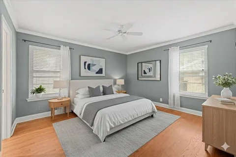 a bedroom with a large bed couch and a window