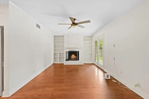 a view of empty room with fireplace and fan
