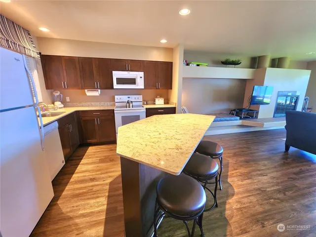a kitchen with stainless steel appliances granite countertop a sink and a refrigerator