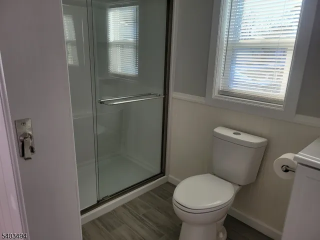 a view of a room with a window and wooden floor