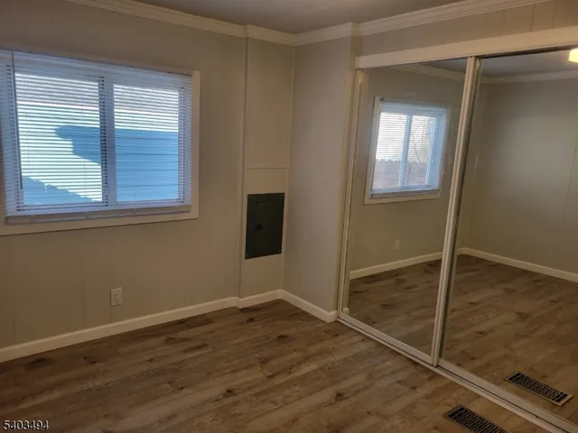 a view of a small space with wooden floor and windows