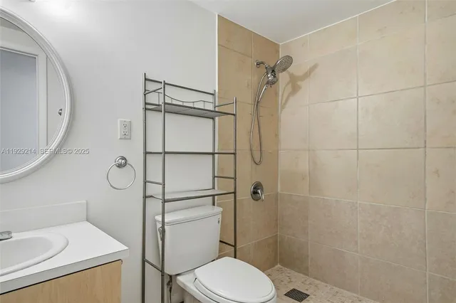 a bathroom with a granite countertop sink a mirror and a shower