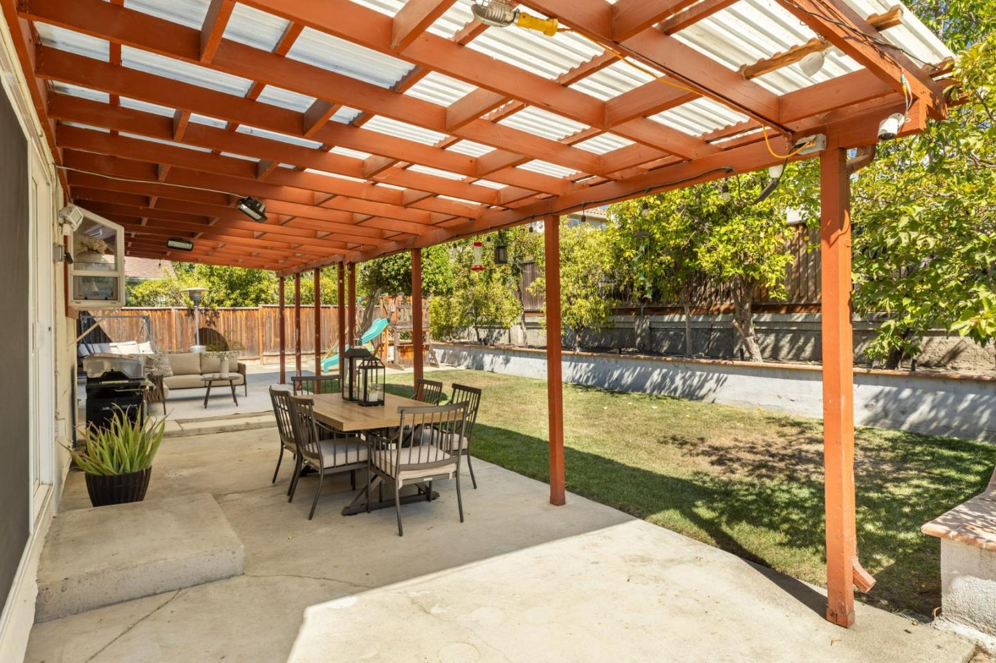1386 Prada Court Milpitas, CA 95035 - Photo 24 of 36 a dining room with furniture and a garden