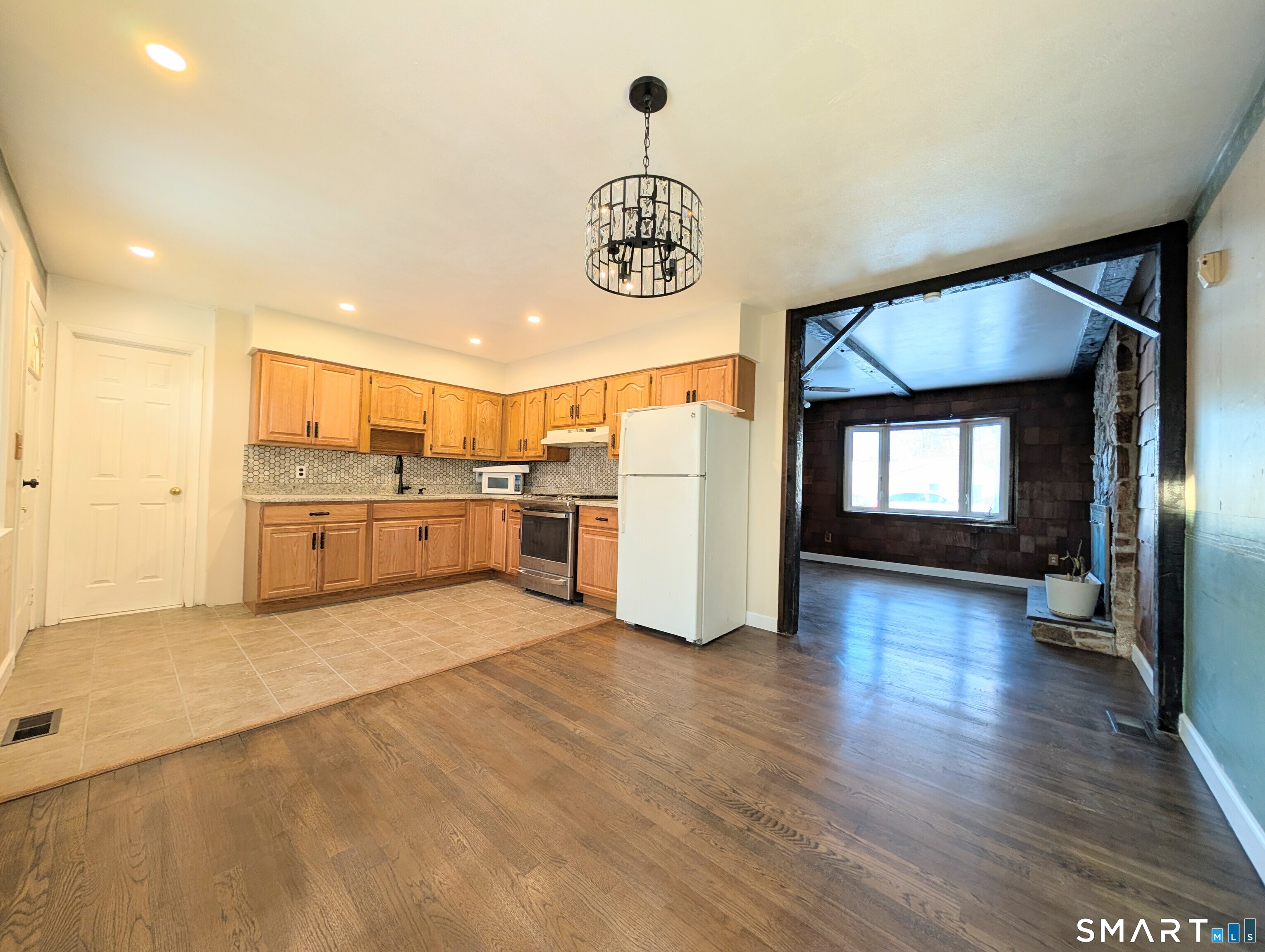139 Little Deer Road Bridgeport, CT 06606 - Photo 11 of 35 a view of a kitchen with a sink cabinets and wooden floor