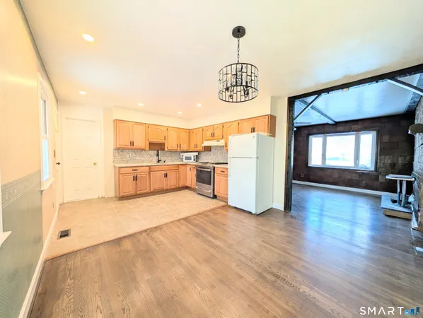 a view of kitchen with furniture and wooden floor