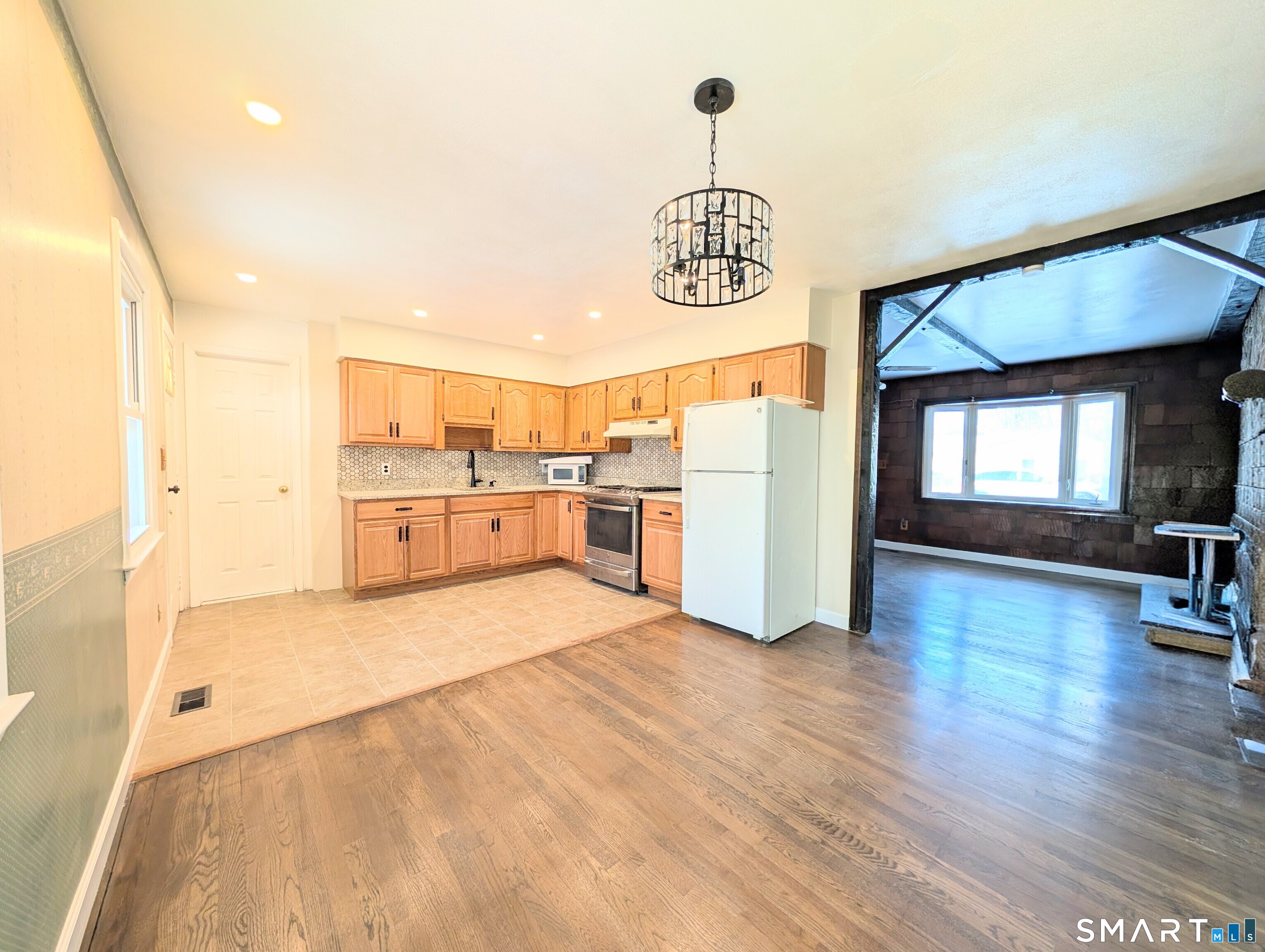 139 Little Deer Road Bridgeport, CT 06606 - Photo 12 of 35 a view of kitchen with furniture and wooden floor