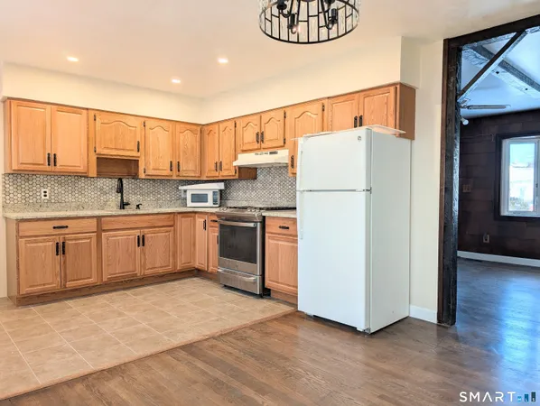 a kitchen with a white cabinets and white appliances