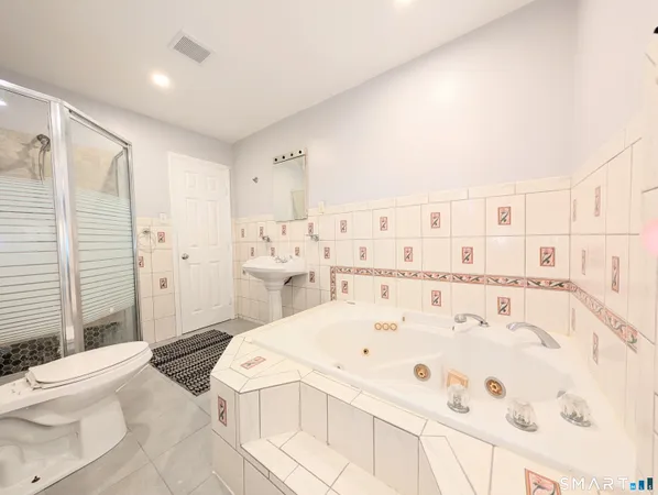 a large white bed in a white room