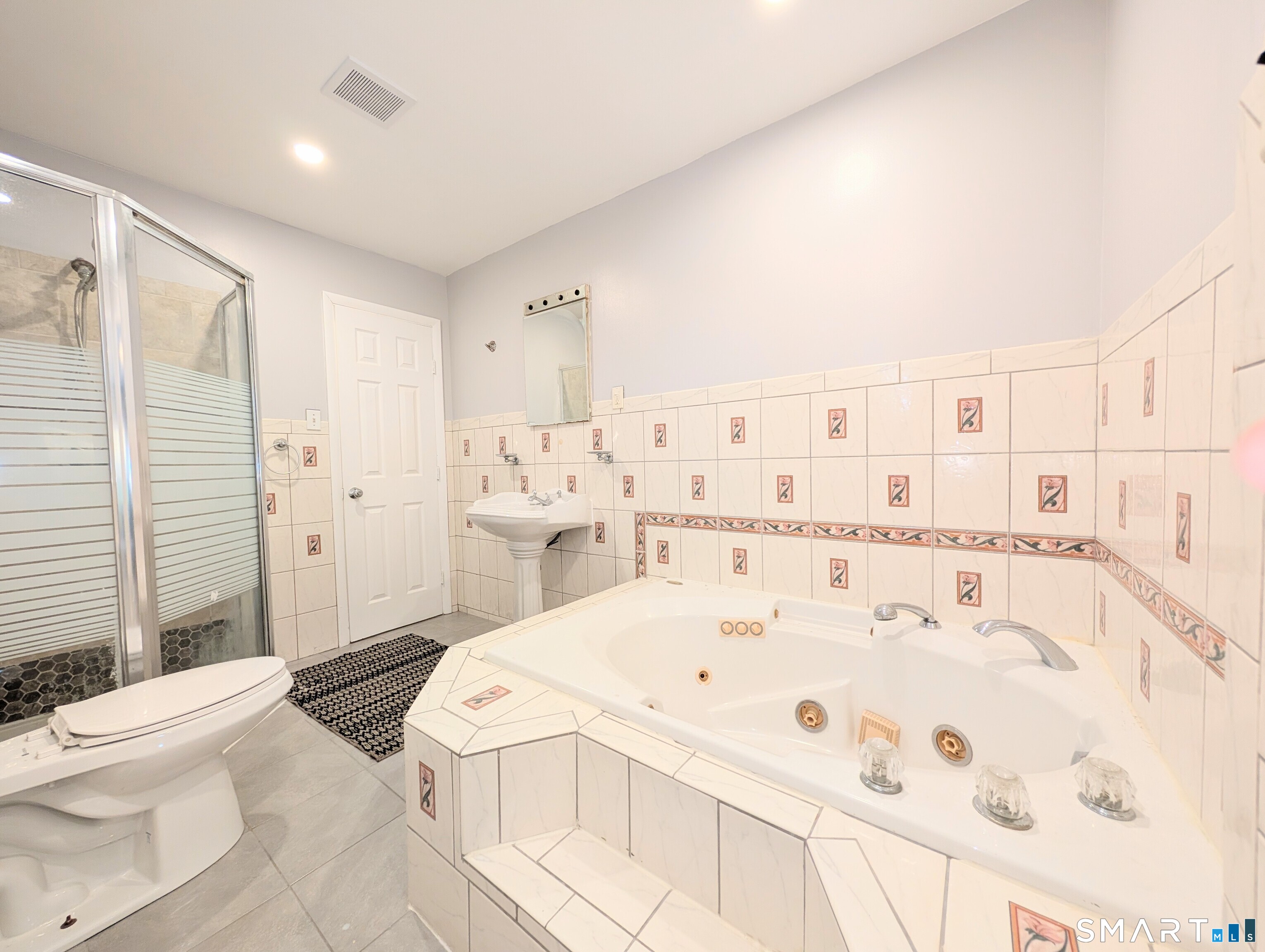 139 Little Deer Road Bridgeport, CT 06606 - Photo 17 of 35 a large white bed in a white room