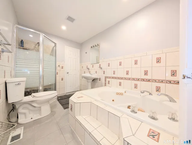 a large bedroom with a bed and a table