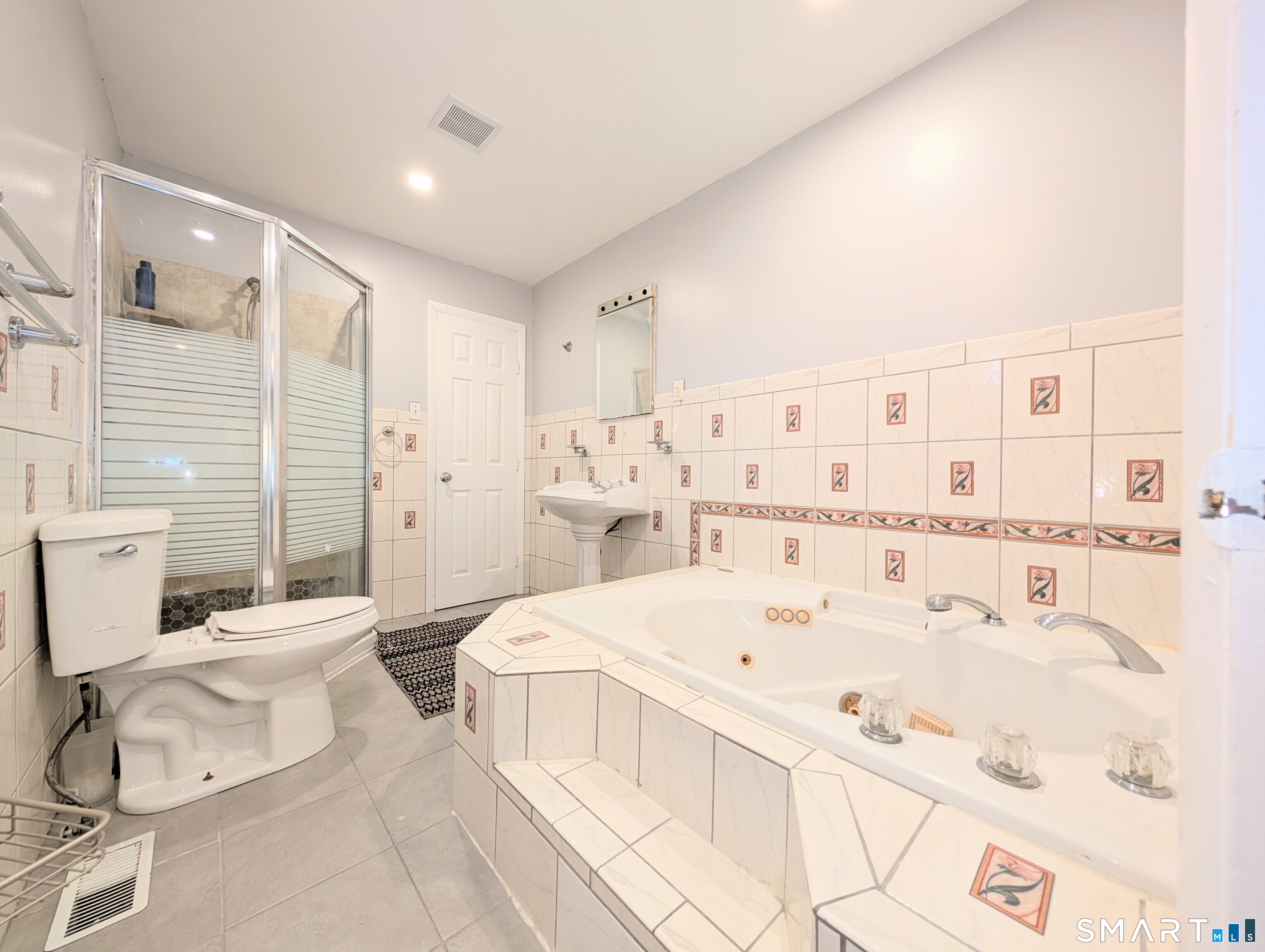 139 Little Deer Road Bridgeport, CT 06606 - Photo 20 of 35 a large bedroom with a bed and a table