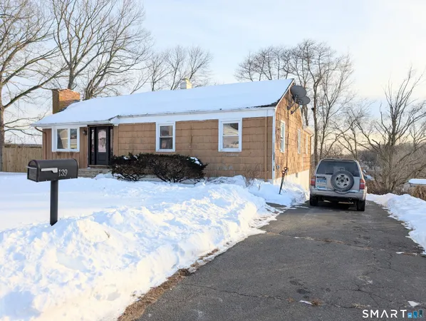 a view of a house with a yard covered in snow