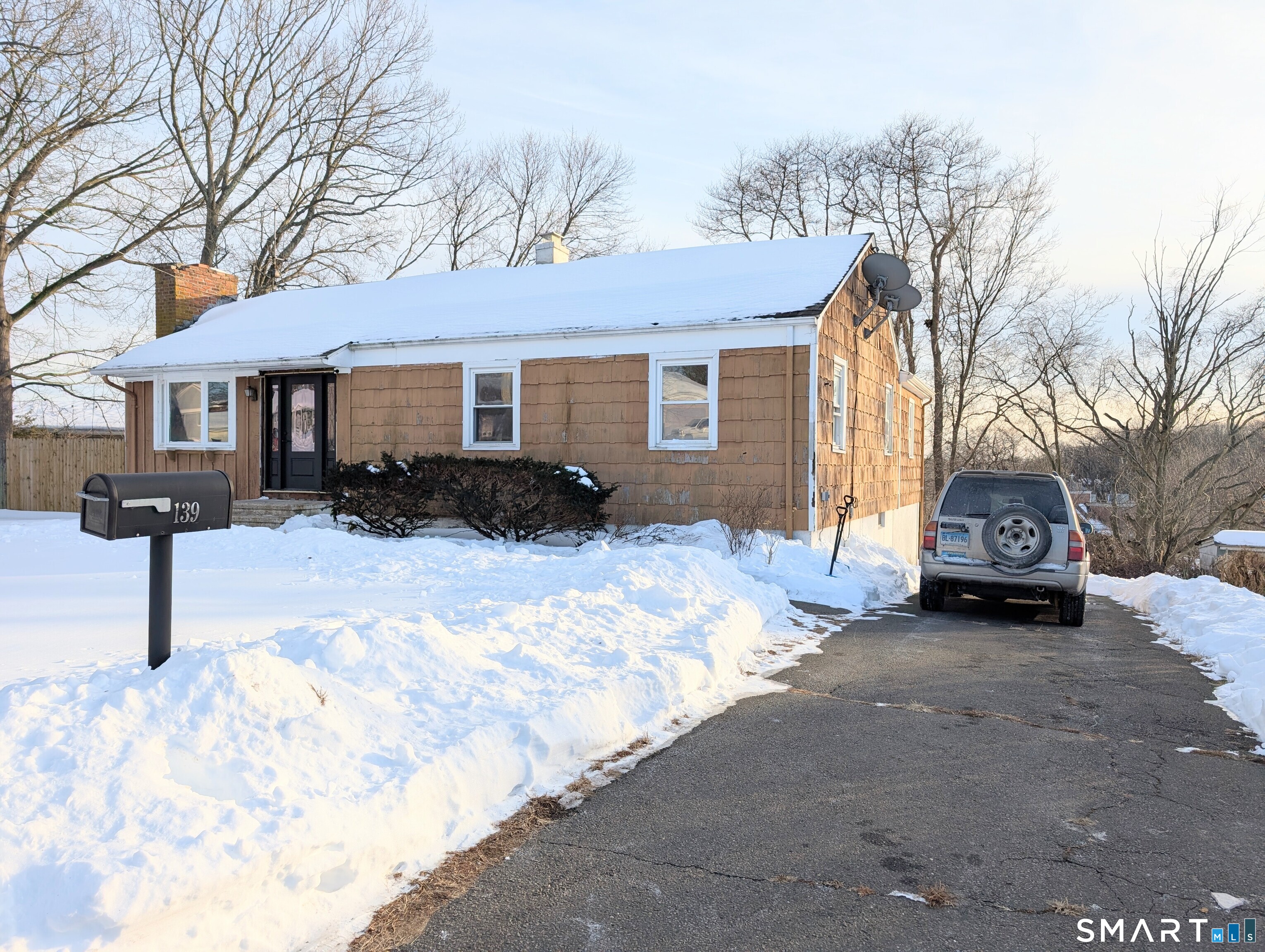 139 Little Deer Road Bridgeport, CT 06606 - Photo 2 of 35 a view of a house with a yard covered in snow