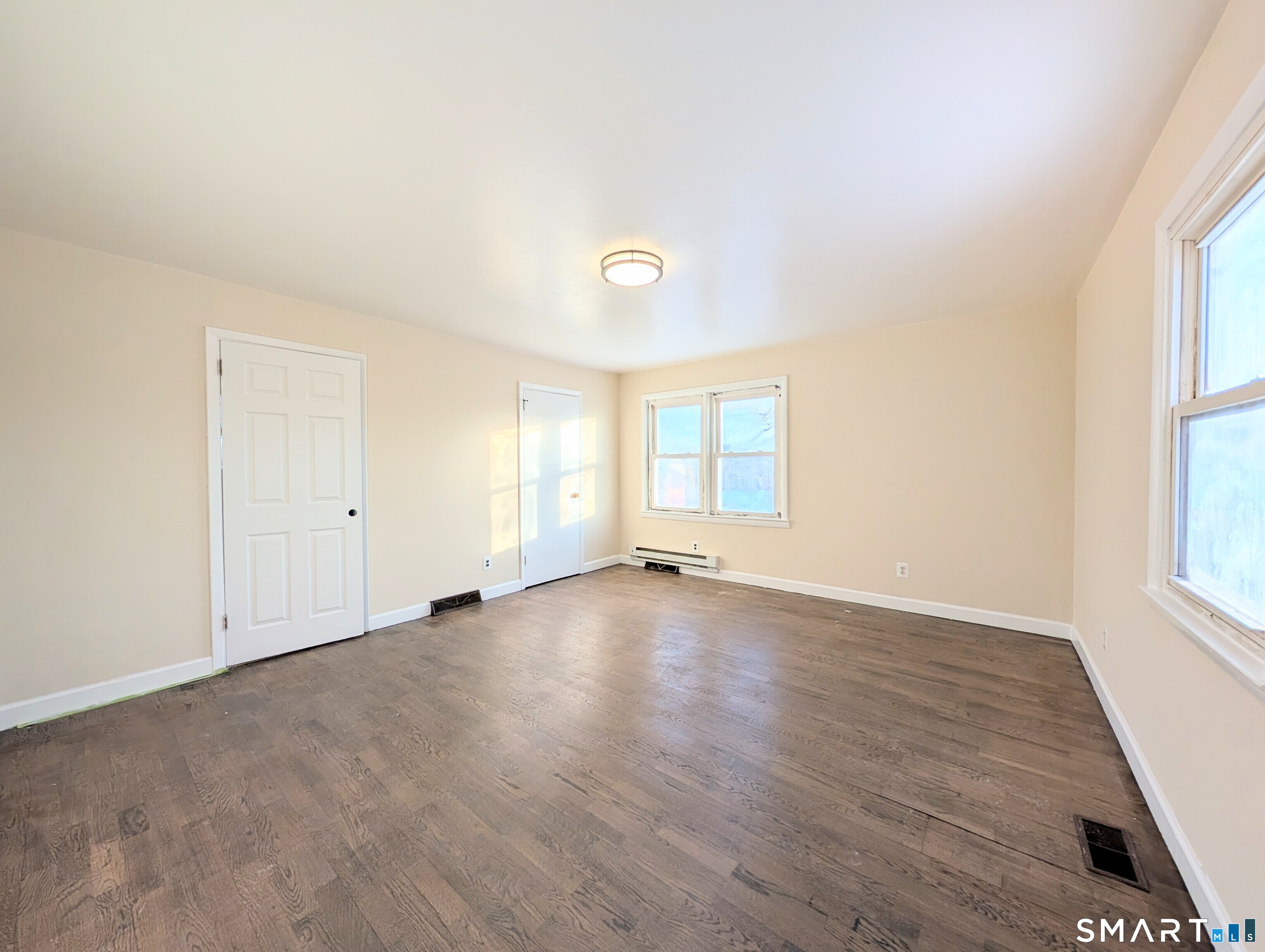 139 Little Deer Road Bridgeport, CT 06606 - Photo 22 of 35 an empty room with wooden floor and windows