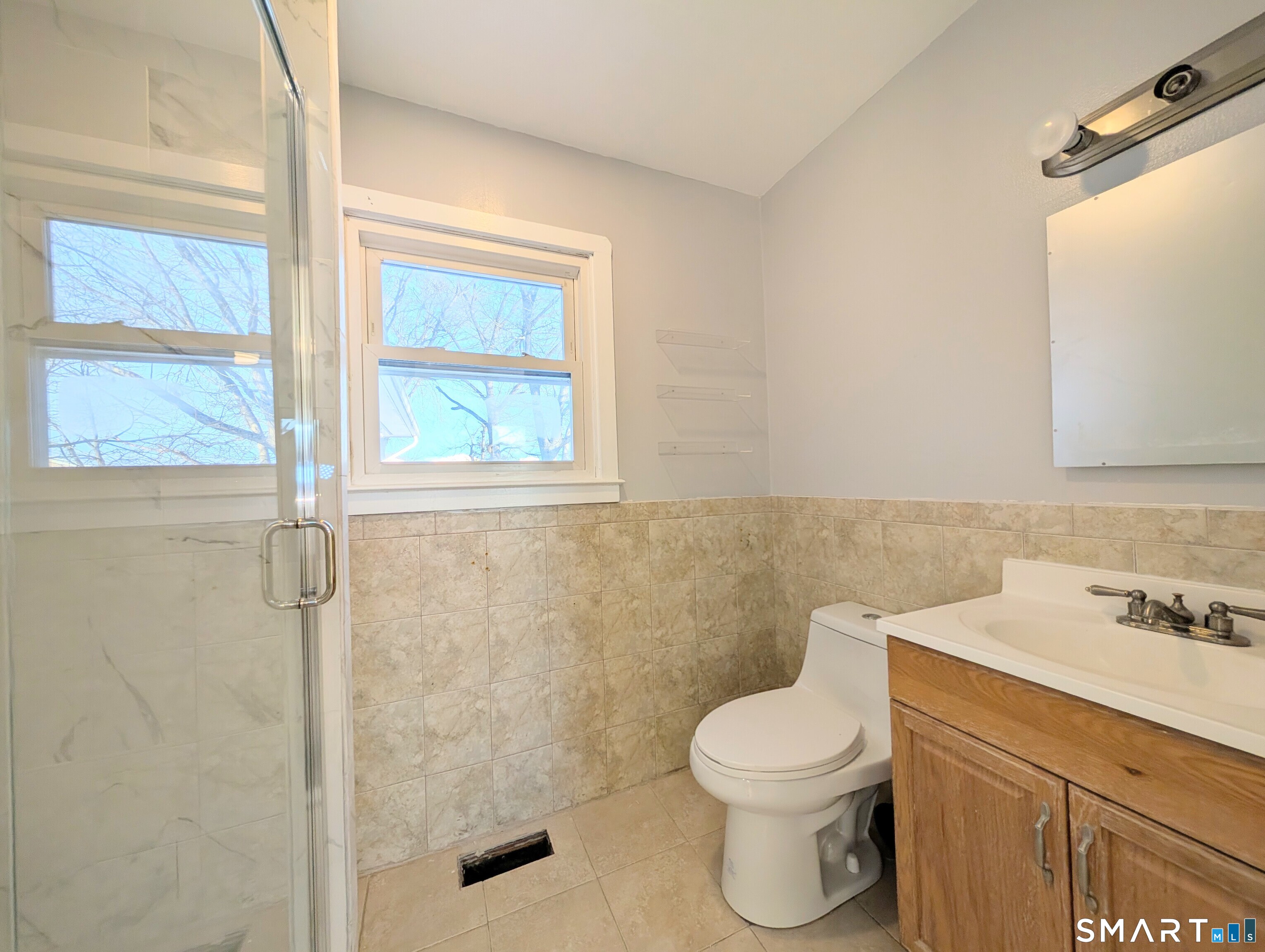 139 Little Deer Road Bridgeport, CT 06606 - Photo 24 of 35 a bathroom with a toilet sink and a shower