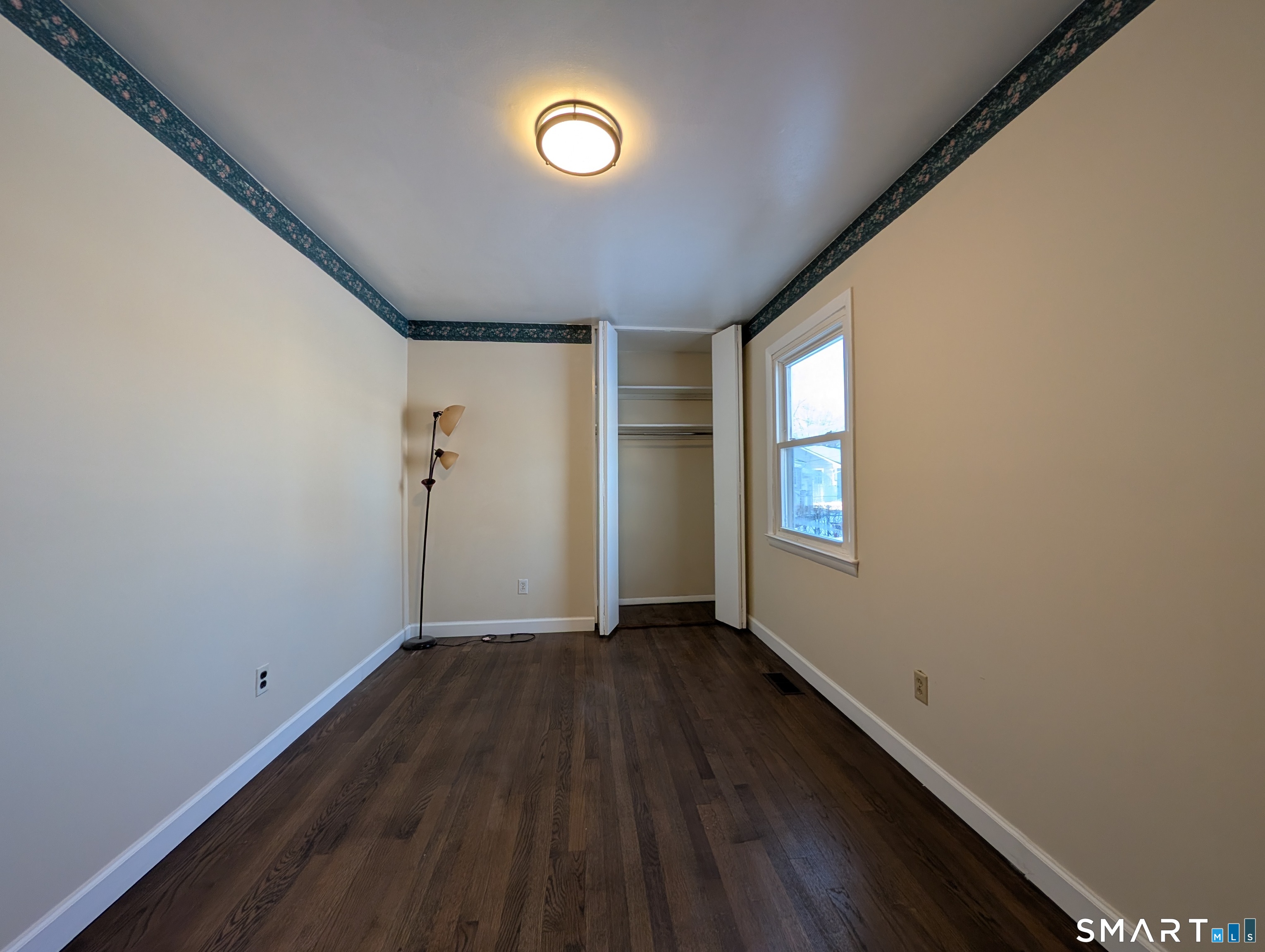 139 Little Deer Road Bridgeport, CT 06606 - Photo 32 of 35 a view of an empty room with wooden floor and a window