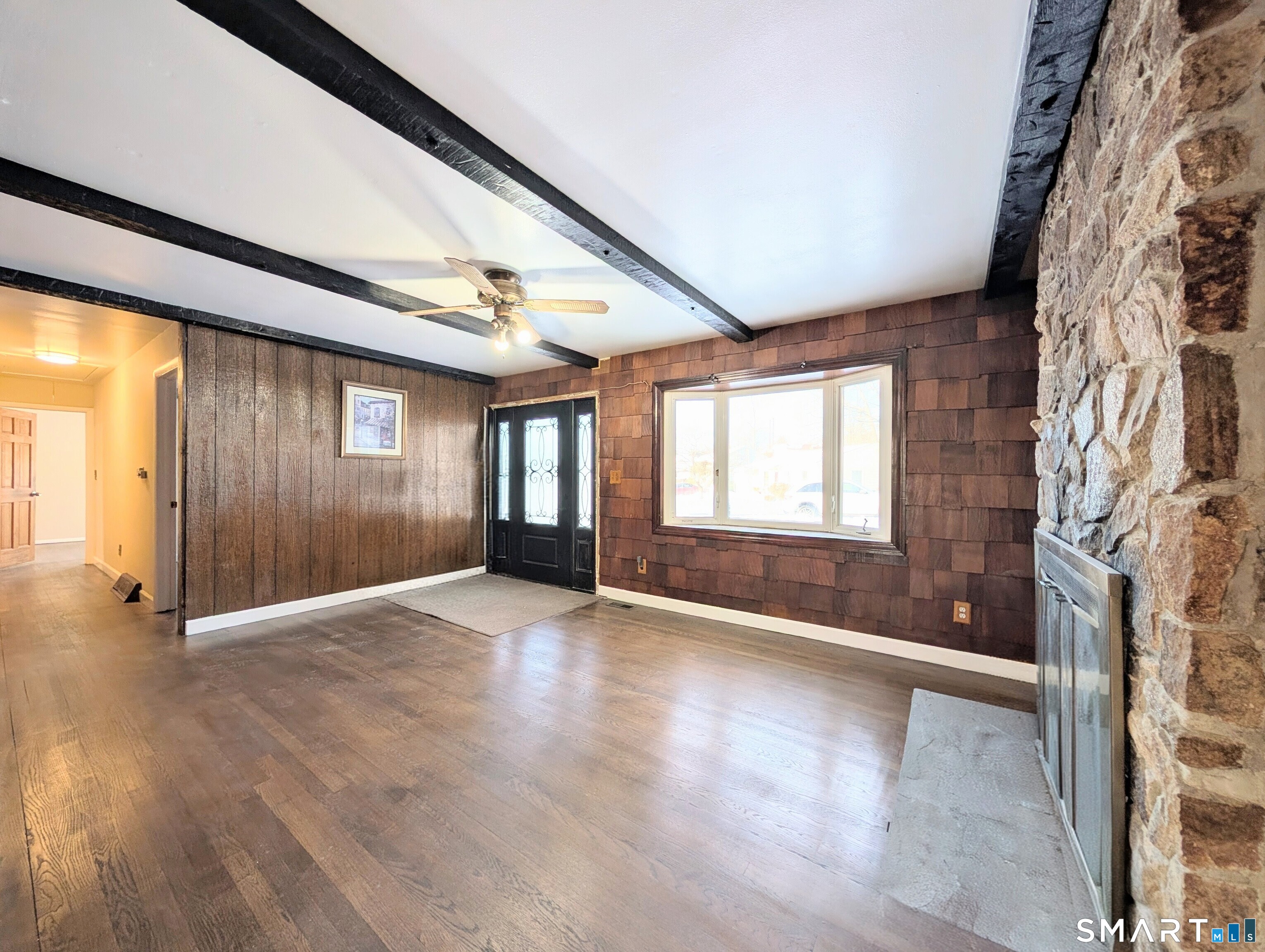 139 Little Deer Road Bridgeport, CT 06606 - Photo 4 of 35 an empty room with wooden floor and windows