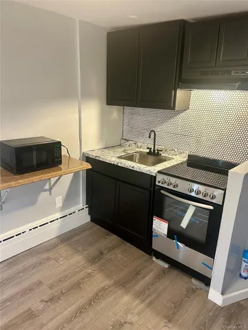 a kitchen with stainless steel appliances granite countertop a sink and a stove