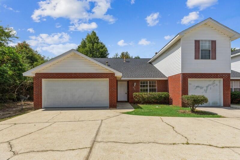 808 Valley Road Crestview, FL 32539 - Photo 1 of 35 a front view of a house with a yard and garage