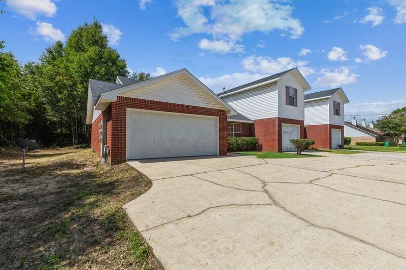 808 Valley Road Crestview, FL 32539 - Photo 2 of 35 a front view of a house with a yard and garage