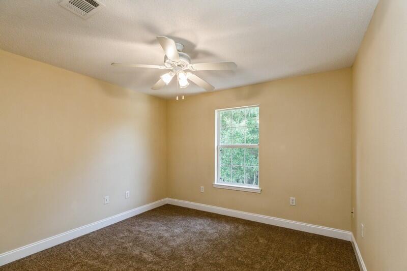 808 Valley Road Crestview, FL 32539 - Photo 25 of 35 an empty room with windows and fan