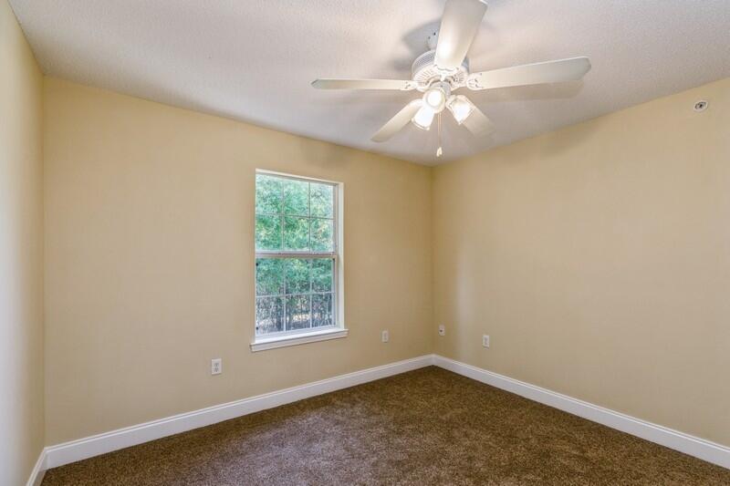 808 Valley Road Crestview, FL 32539 - Photo 26 of 35 an empty room with a window and a fan