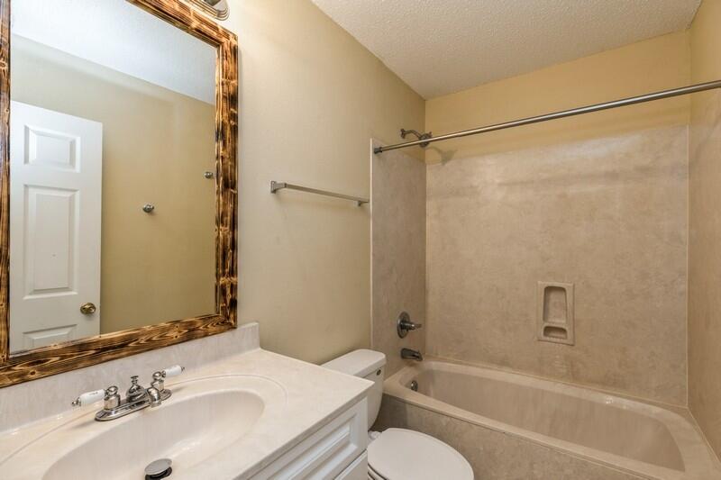 808 Valley Road Crestview, FL 32539 - Photo 28 of 35 a bathroom with a granite countertop sink toilet and shower