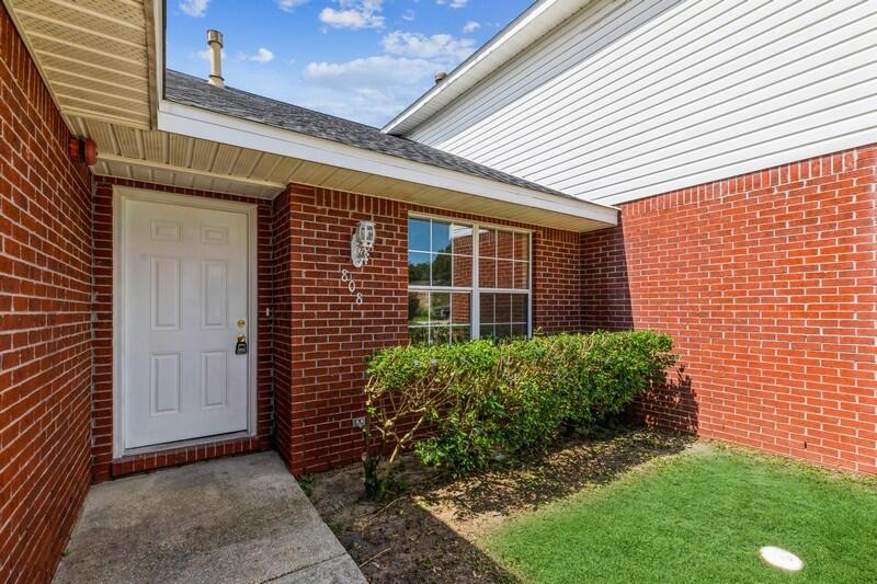 808 Valley Road Crestview, FL 32539 - Photo 6 of 35 a view of a brick house with a yard