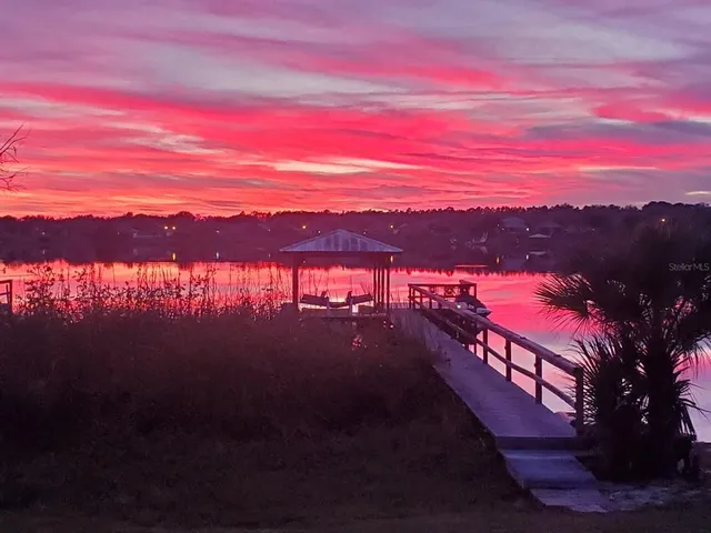 a balcony view with chairs and wooden floor