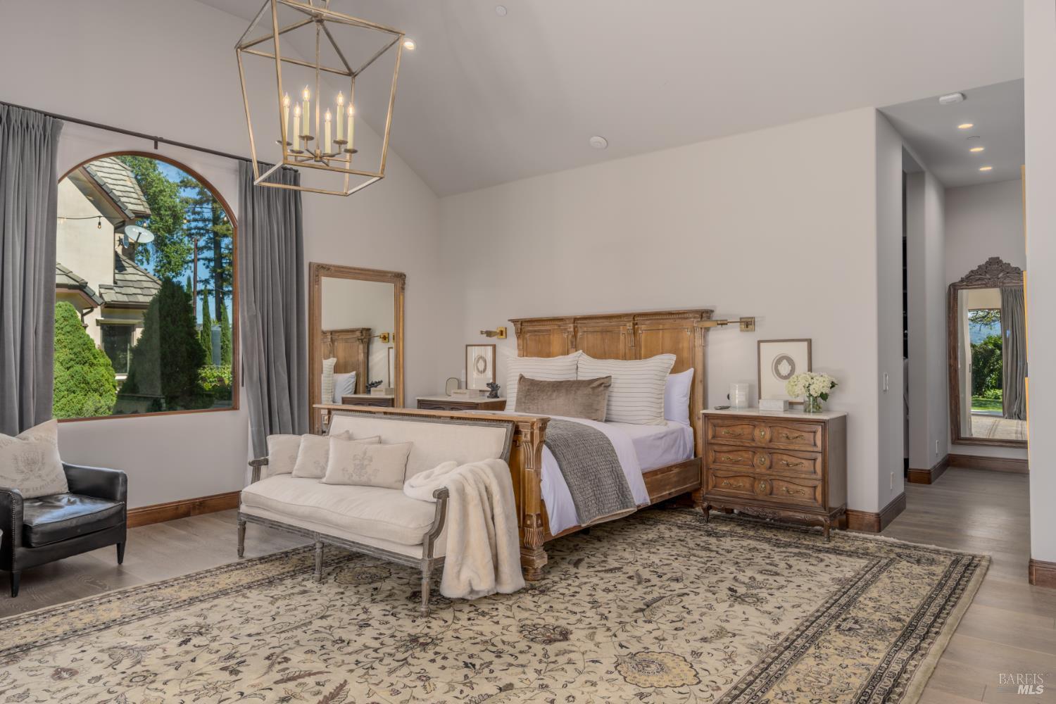 5045 Big Ranch Road Napa, CA 94558 - Photo 24 of 71 a bed room with a bed and a chandelier