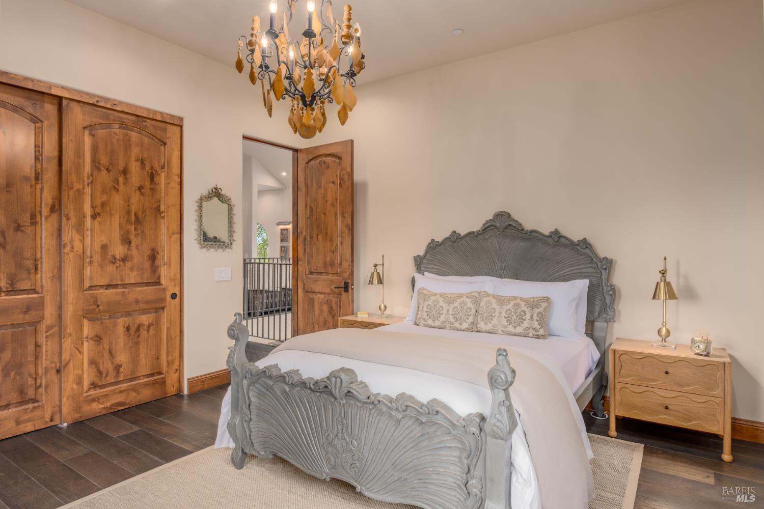 5045 Big Ranch Road Napa, CA 94558 - Photo 40 of 71 a bedroom with a bed and a chandelier