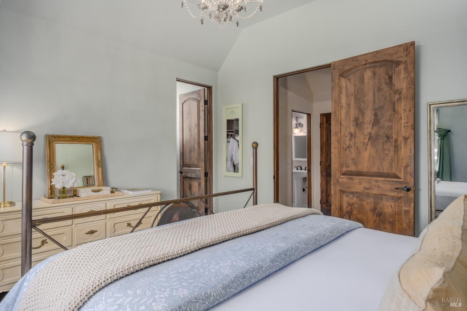 5045 Big Ranch Road Napa, CA 94558 - Photo 55 of 71 a bedroom with a bed and a chandelier
